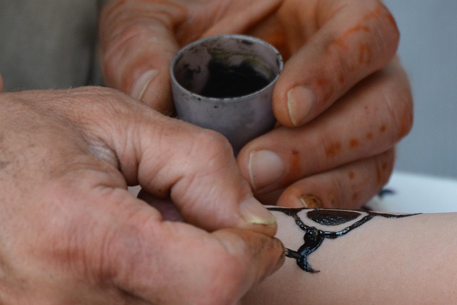 tattoo artist working on fine line tattoo in clean studio